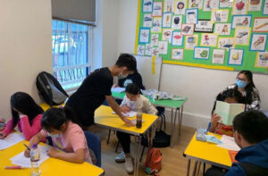 Wing yu, Nicky and Lin teach children Maths at the Homework Club